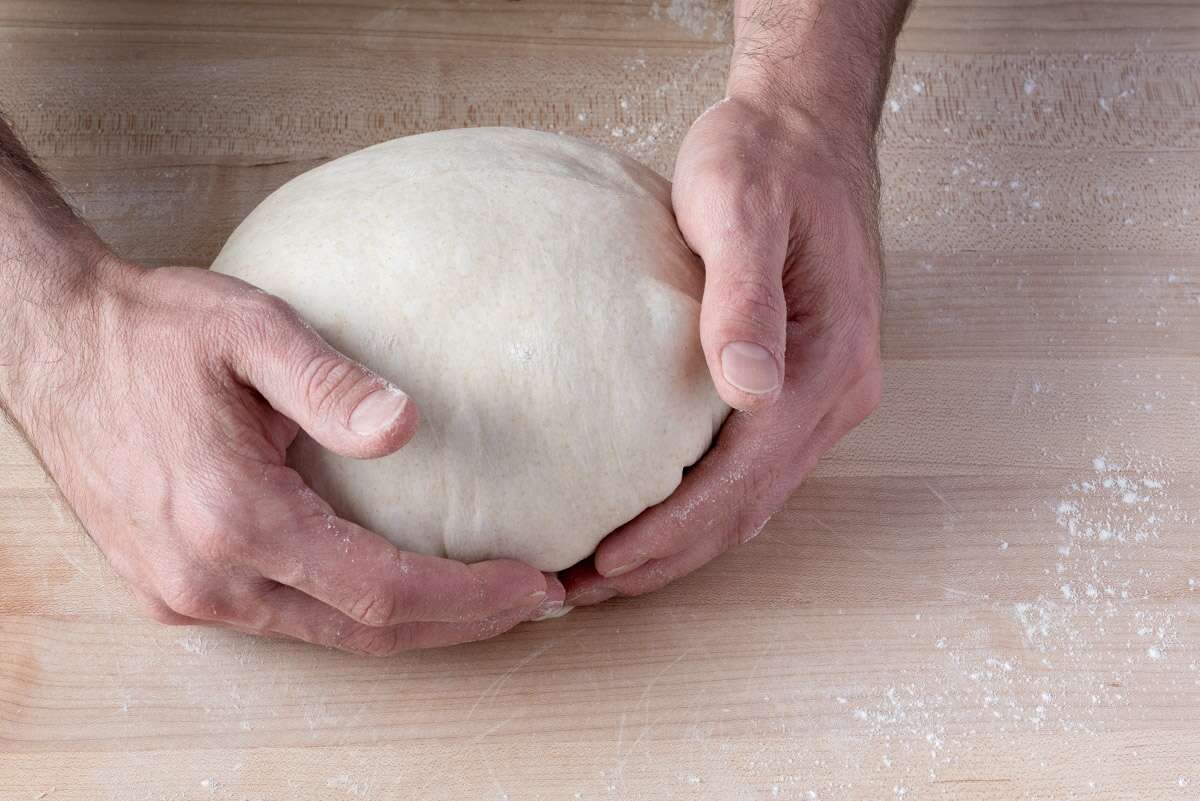 Hands shaping bread dough